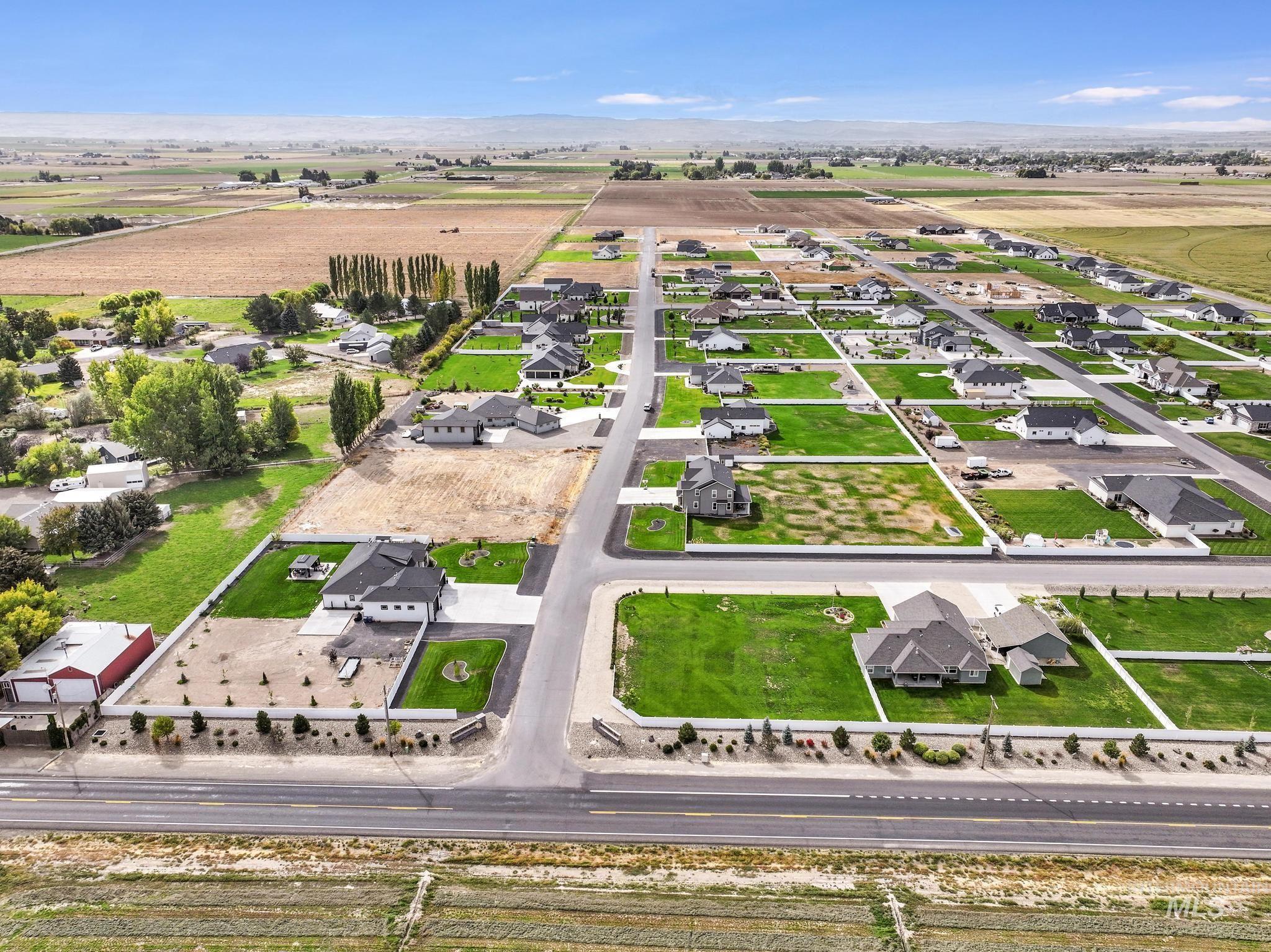 Aerial view of property's location with nearby suburban area