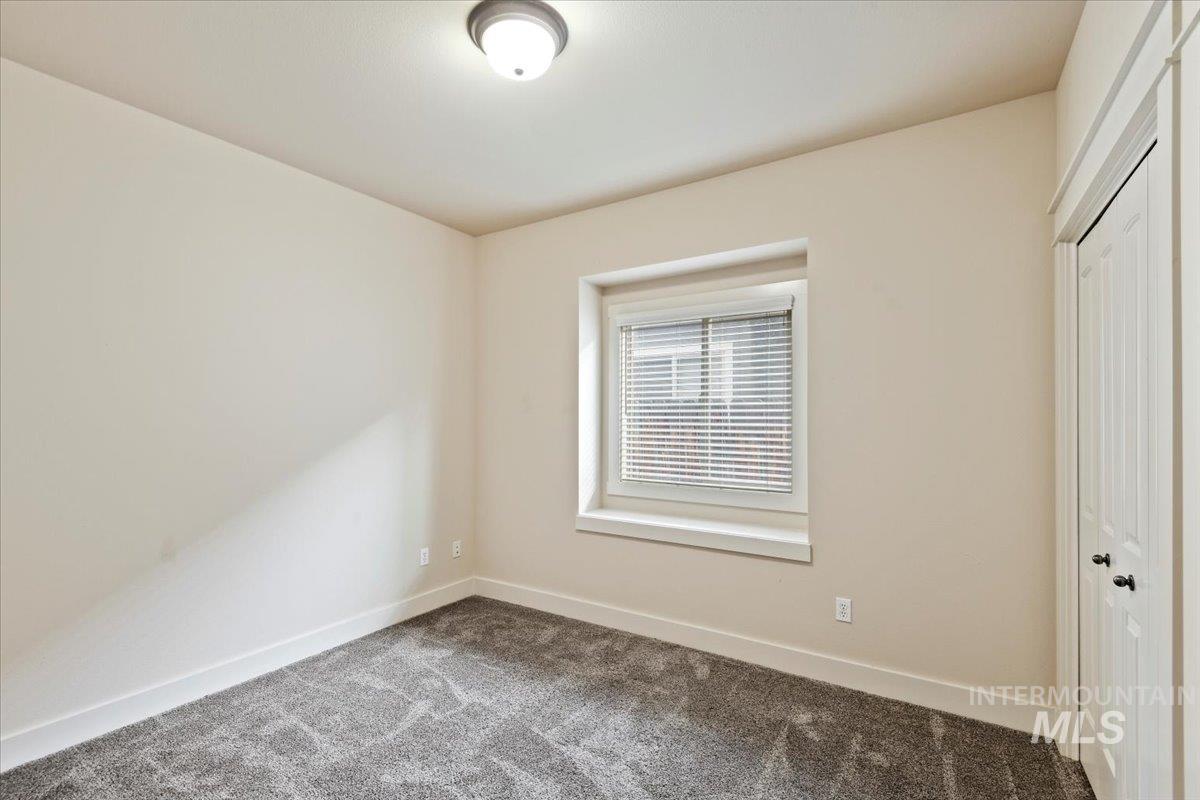 Unfurnished bedroom featuring a closet and carpet