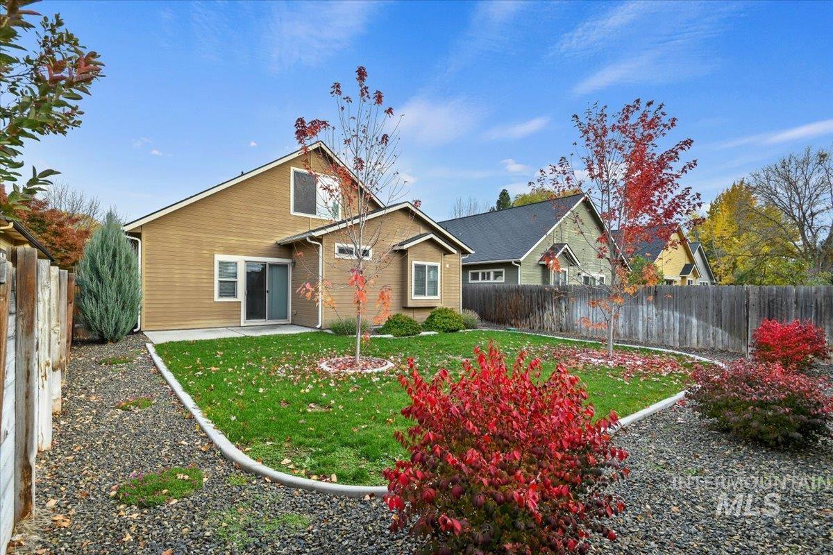 Back of house with a fenced backyard, a patio area, and brick siding