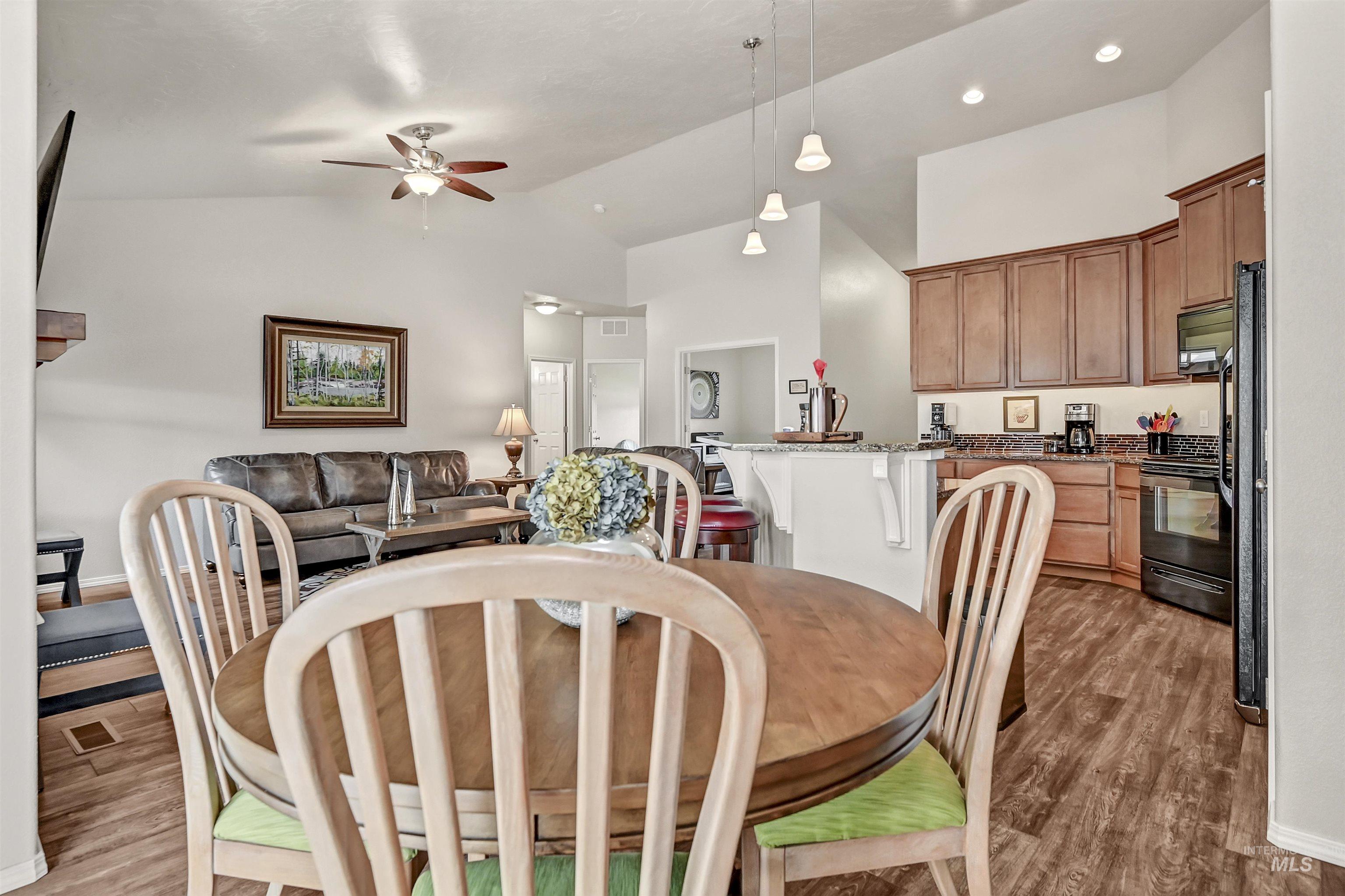 Dining area with ceiling fan, light wood-style floors, high vaulted ceiling, and recessed lighting