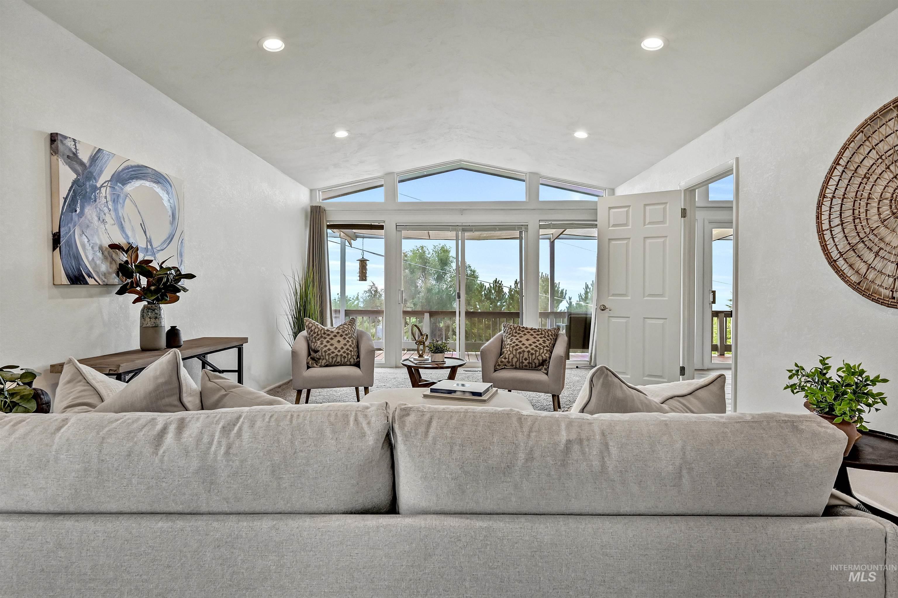 Living room with lofted ceiling and recessed lighting