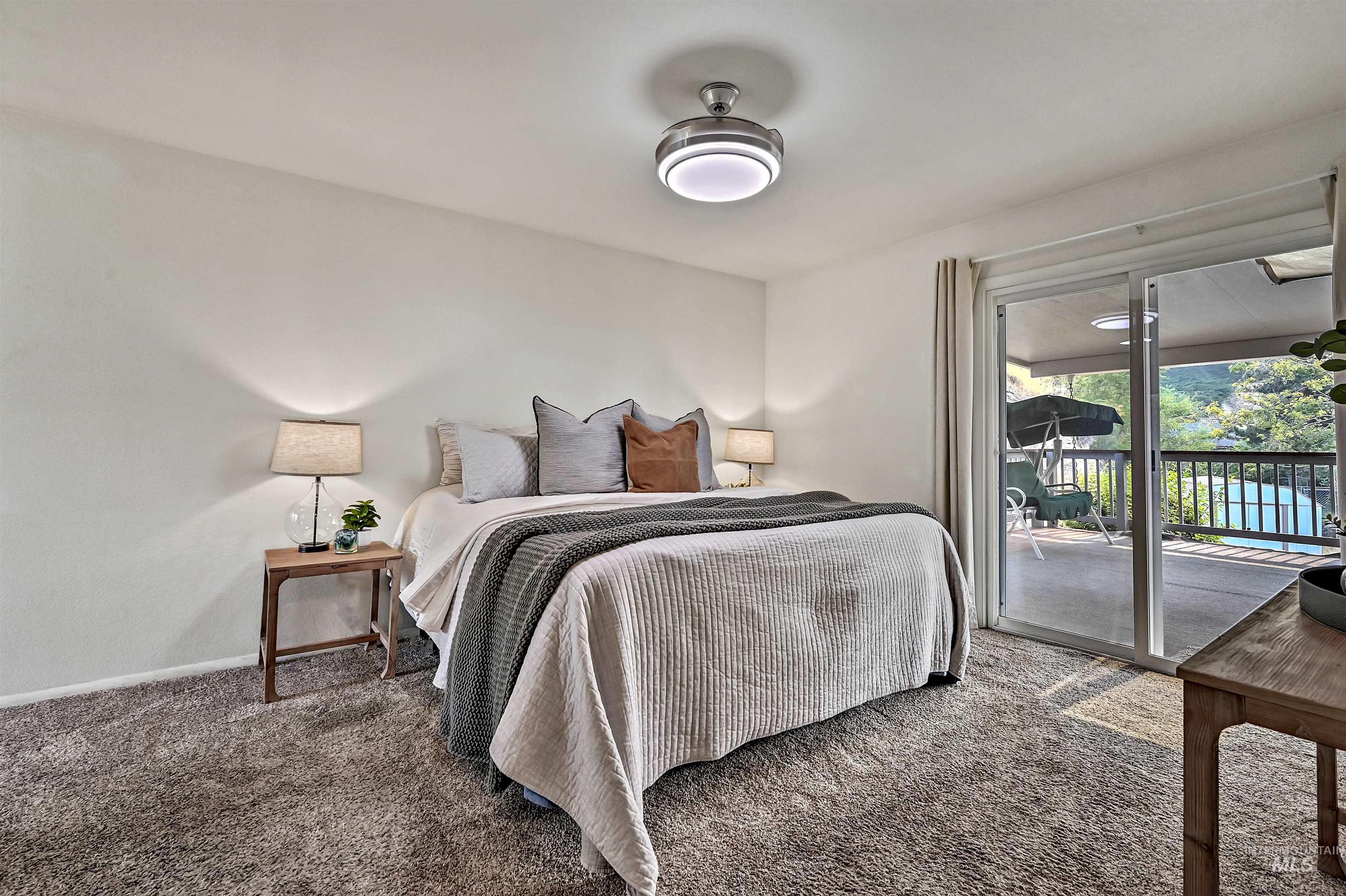 Bedroom featuring carpet flooring and access to exterior