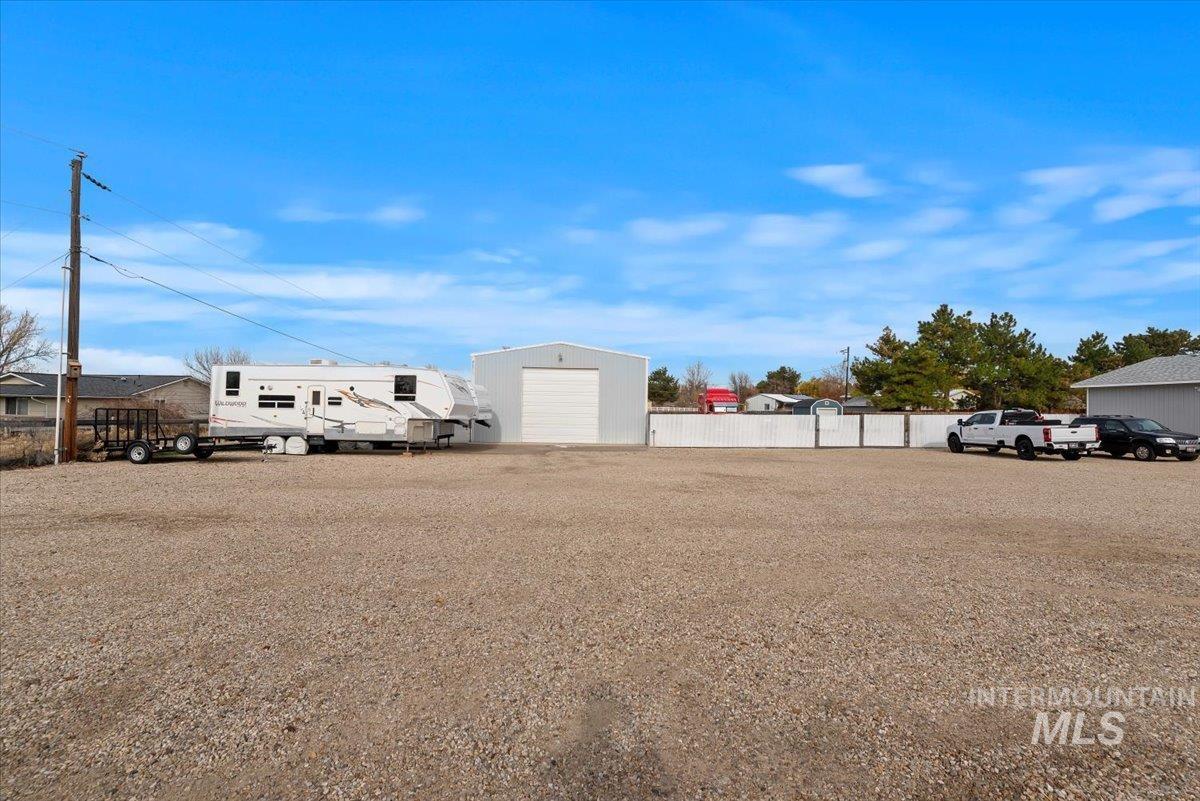 View of yard featuring an outdoor structure and a detached garage