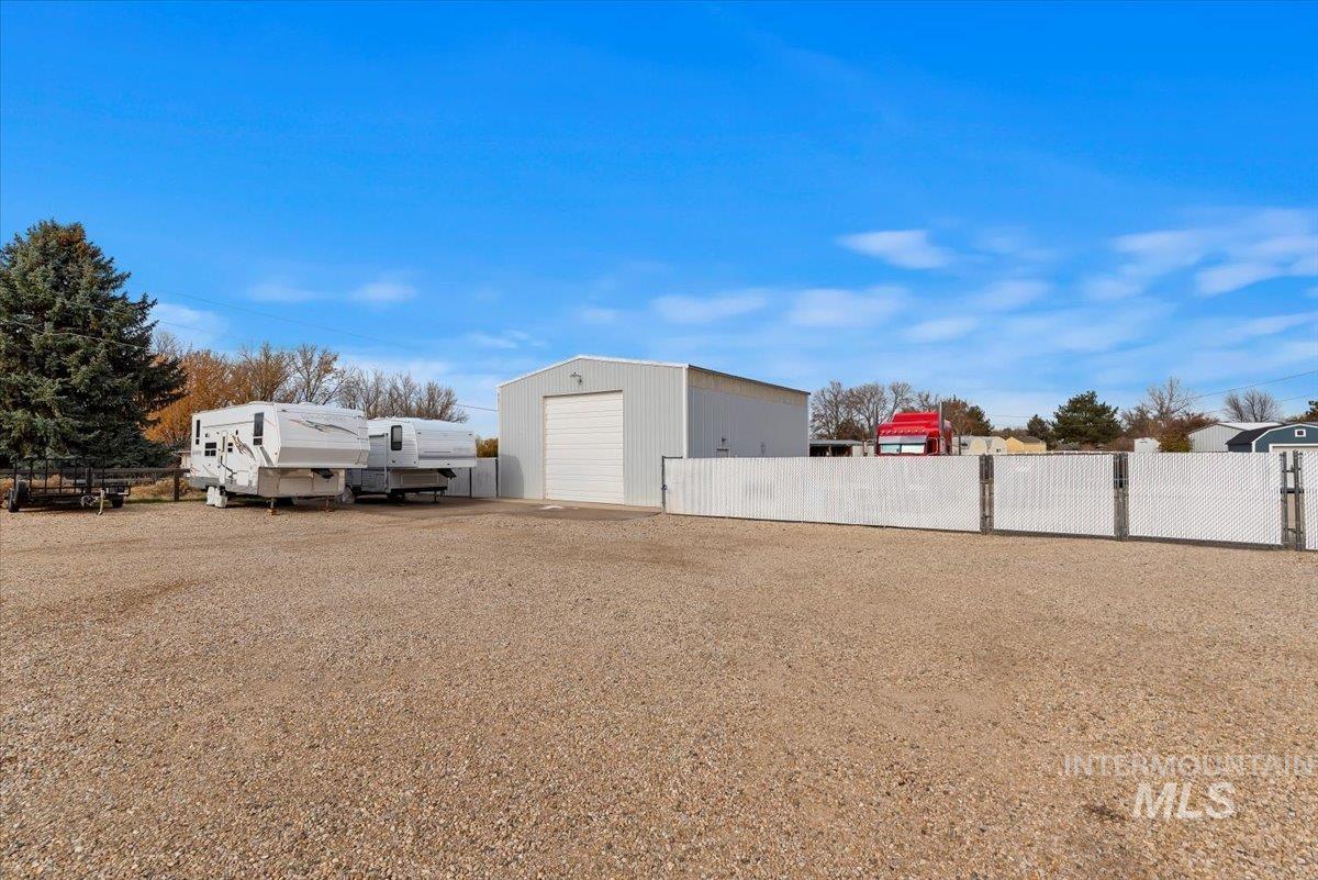 View of yard featuring an outbuilding and a detached garage