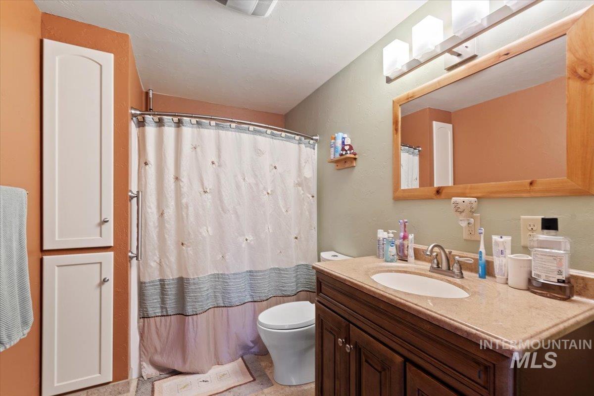 Full bathroom with vanity and a shower with shower curtain