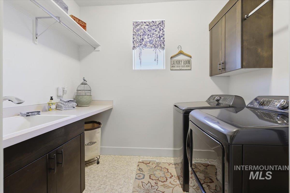 Laundry room with washing machine and clothes dryer and cabinet space