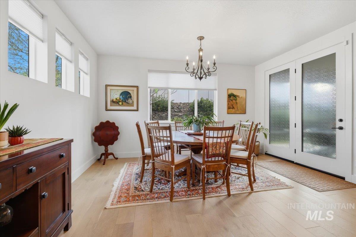 Dining room featuring light wood-style floors and suspended lighting