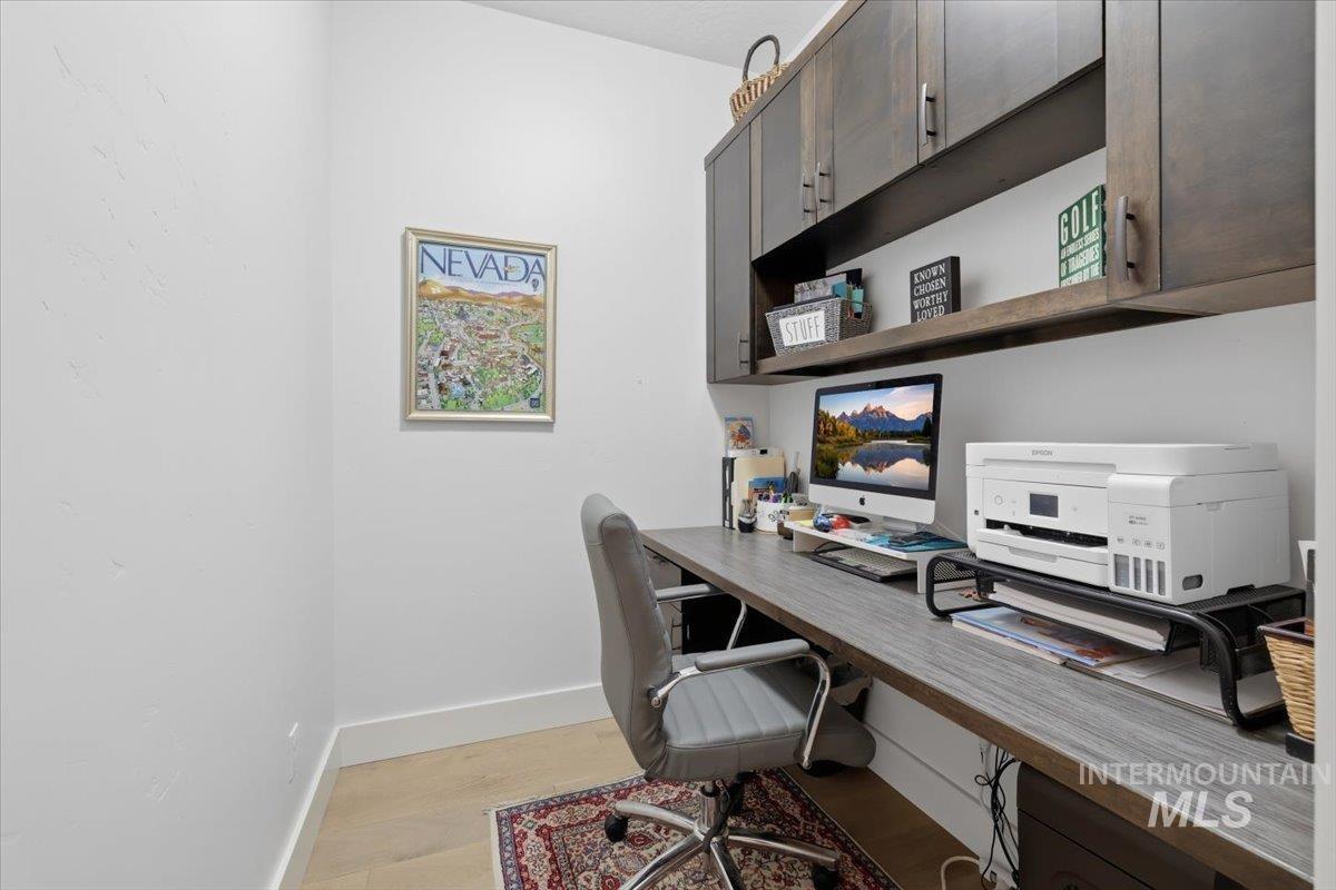 Office area featuring baseboards and light wood-style flooring