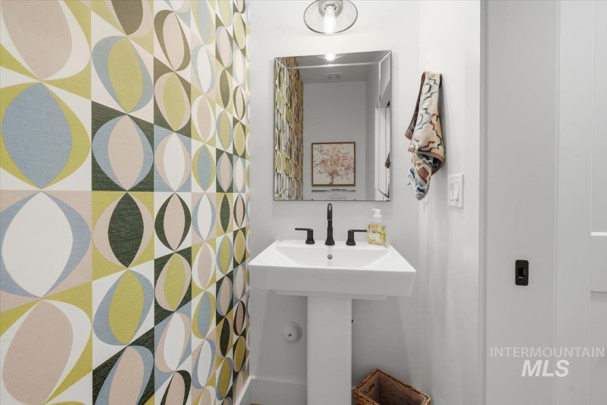 Bathroom featuring a shower with shower curtain and a sink