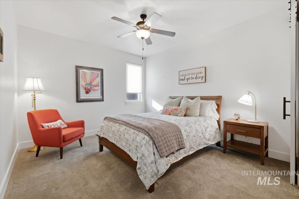 Bedroom featuring ceiling fan and light colored carpet