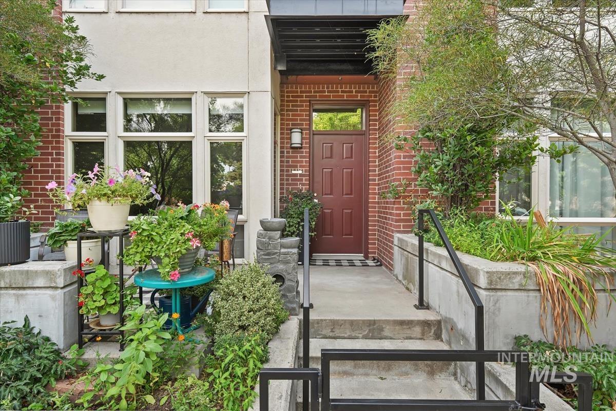 Property entrance with brick siding and stucco siding