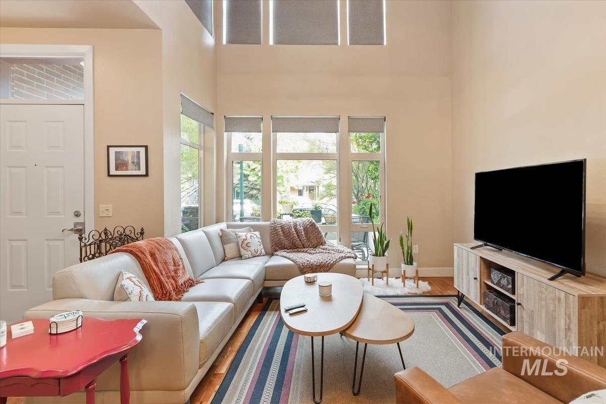 Living room with a high ceiling and wood finished floors
