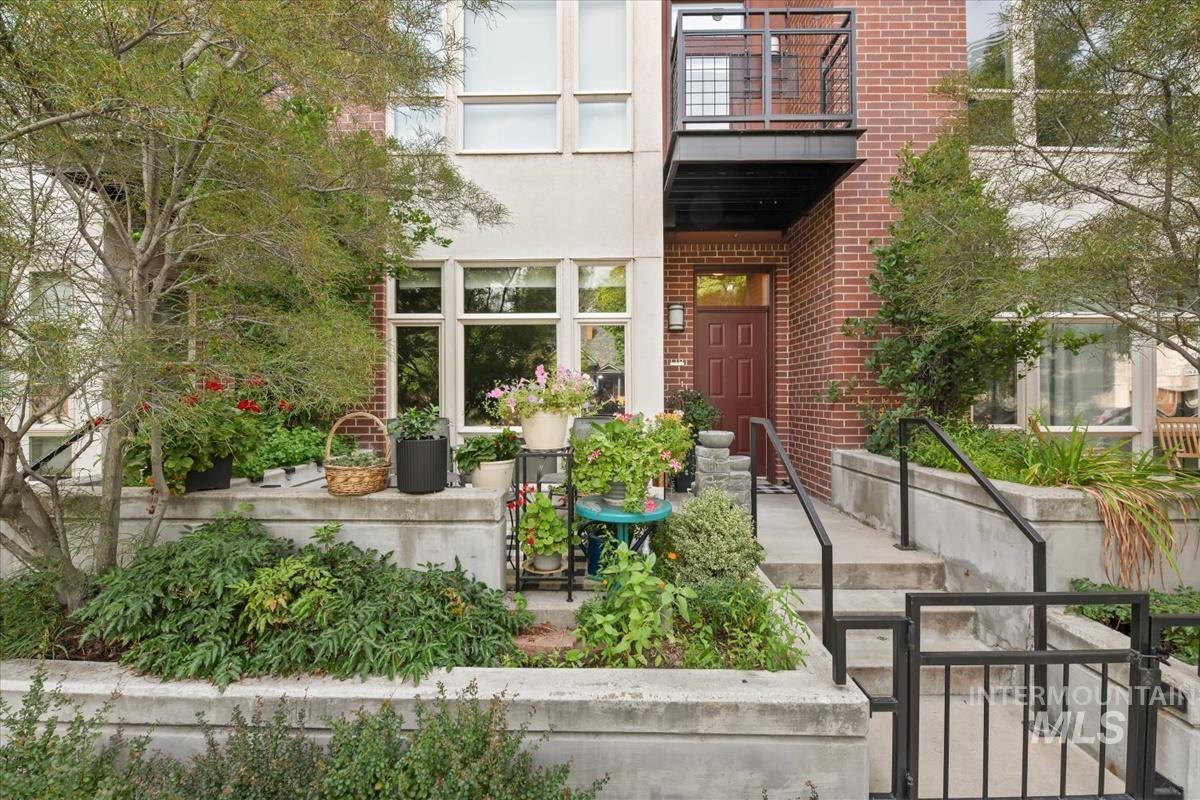 Doorway to property featuring brick siding