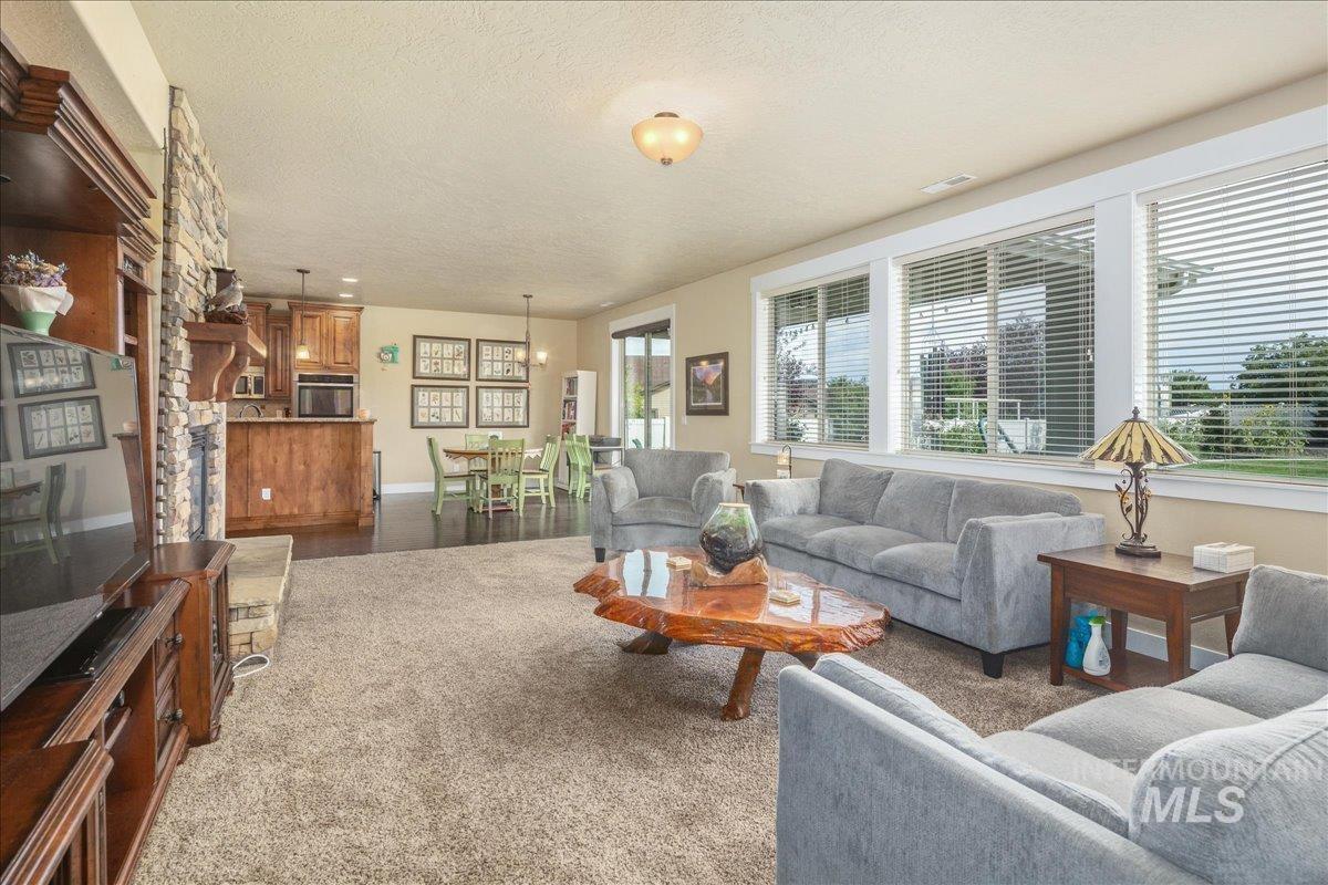 Living room featuring a textured ceiling and carpet floors