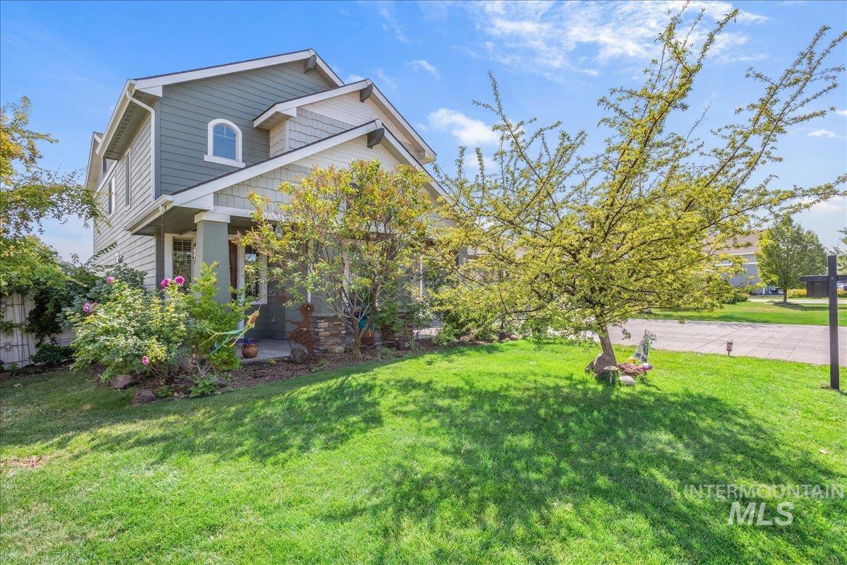View of home's exterior with a yard and a porch