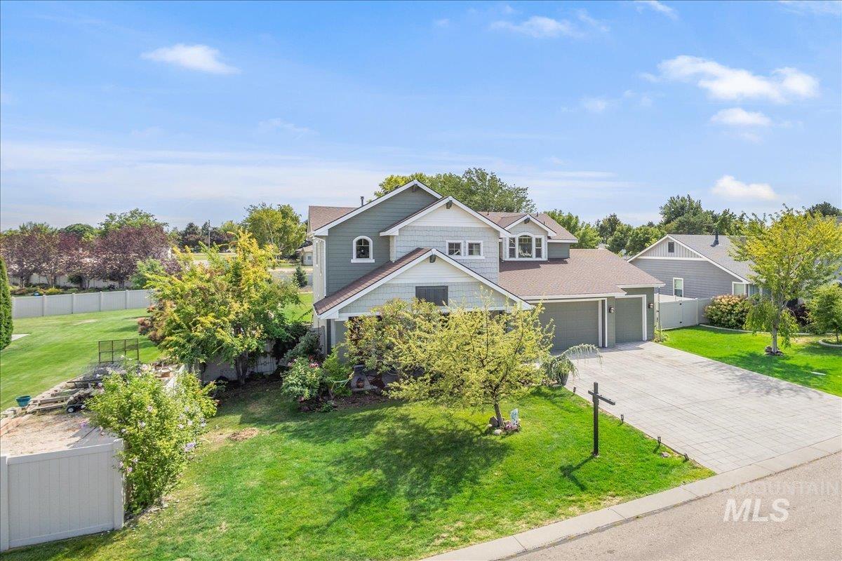 View of front of home with decorative driveway and a garage