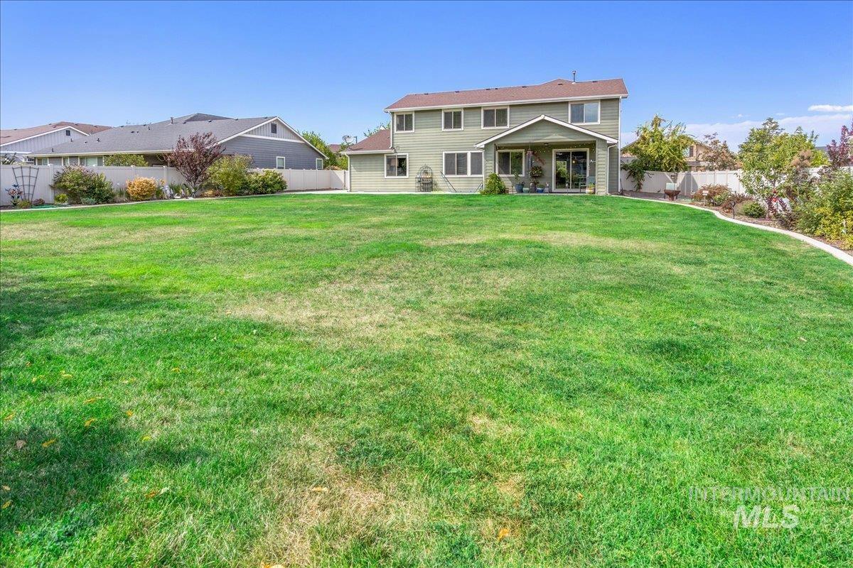 Rear view of property featuring a fenced backyard