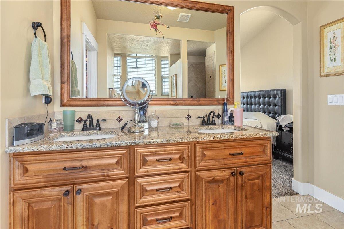 Bathroom featuring double vanity and tile patterned floors