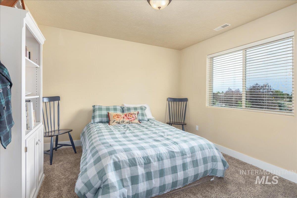 Bedroom featuring carpet floors and a textured ceiling