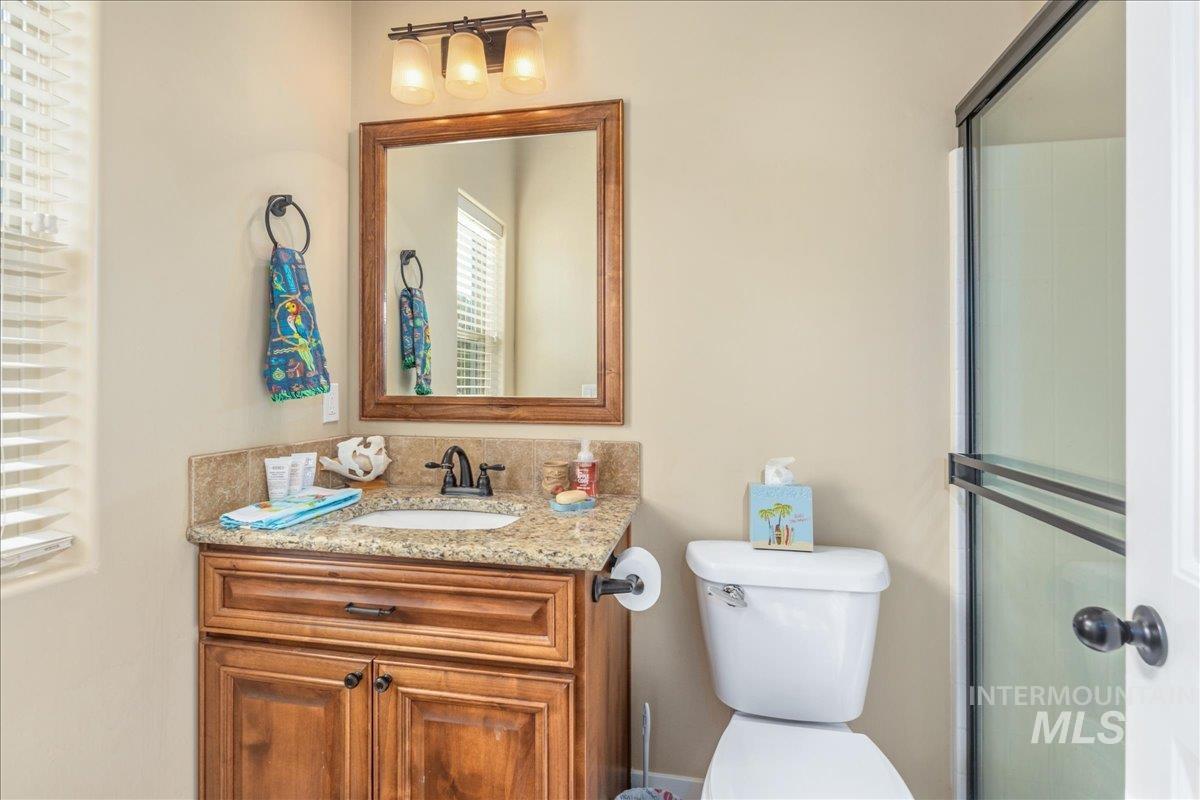 Full bath with vanity and an enclosed shower