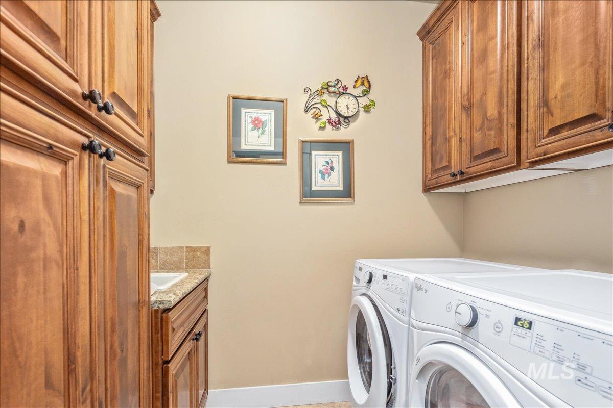 Washroom with washer and dryer and cabinet space