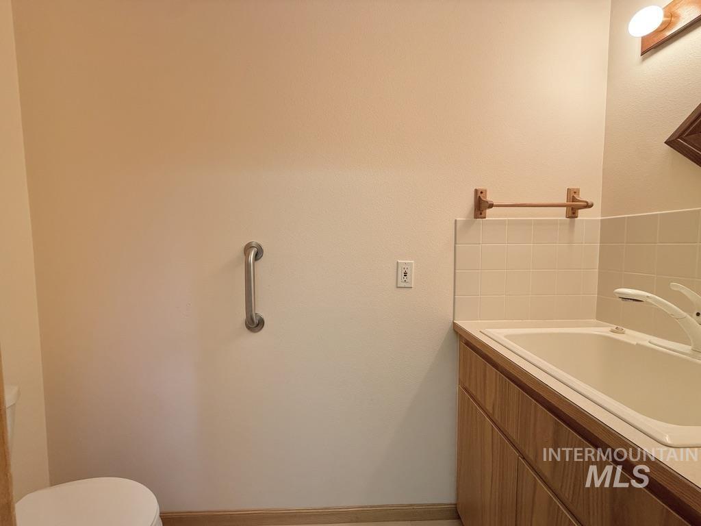 Bathroom with toilet and baseboards