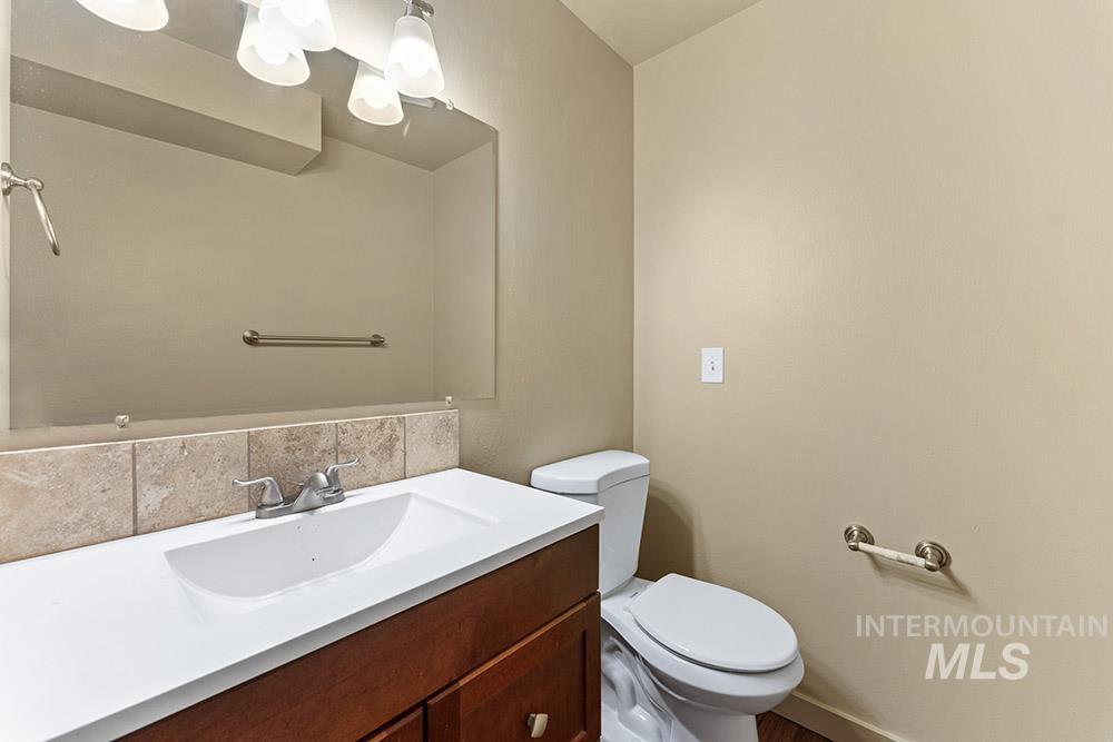 Half bathroom featuring toilet and vanity