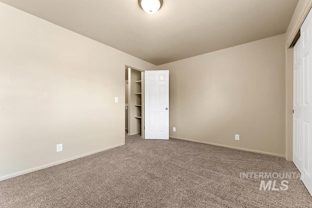 Unfurnished bedroom featuring carpet and a closet