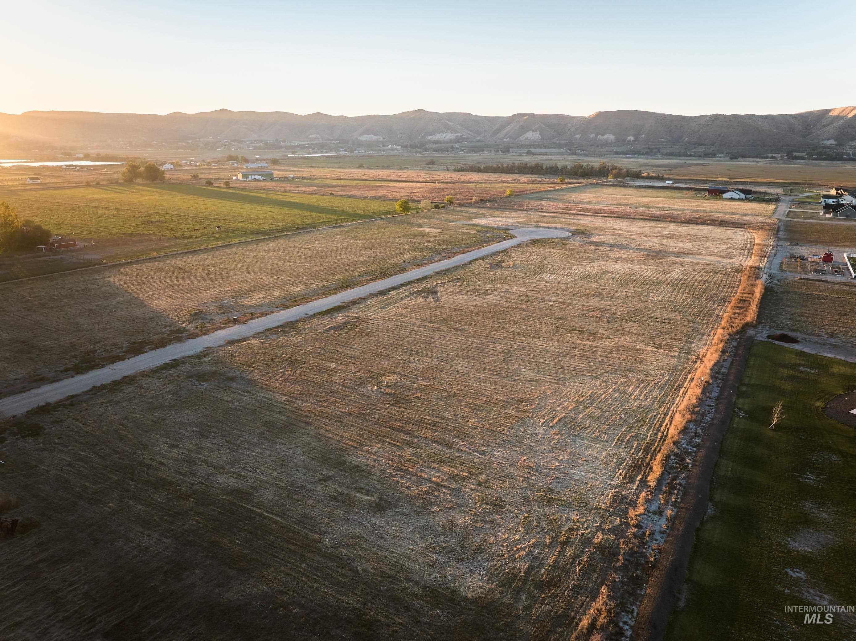 View of rural area featuring abundant farmland and a mountain backdrop
