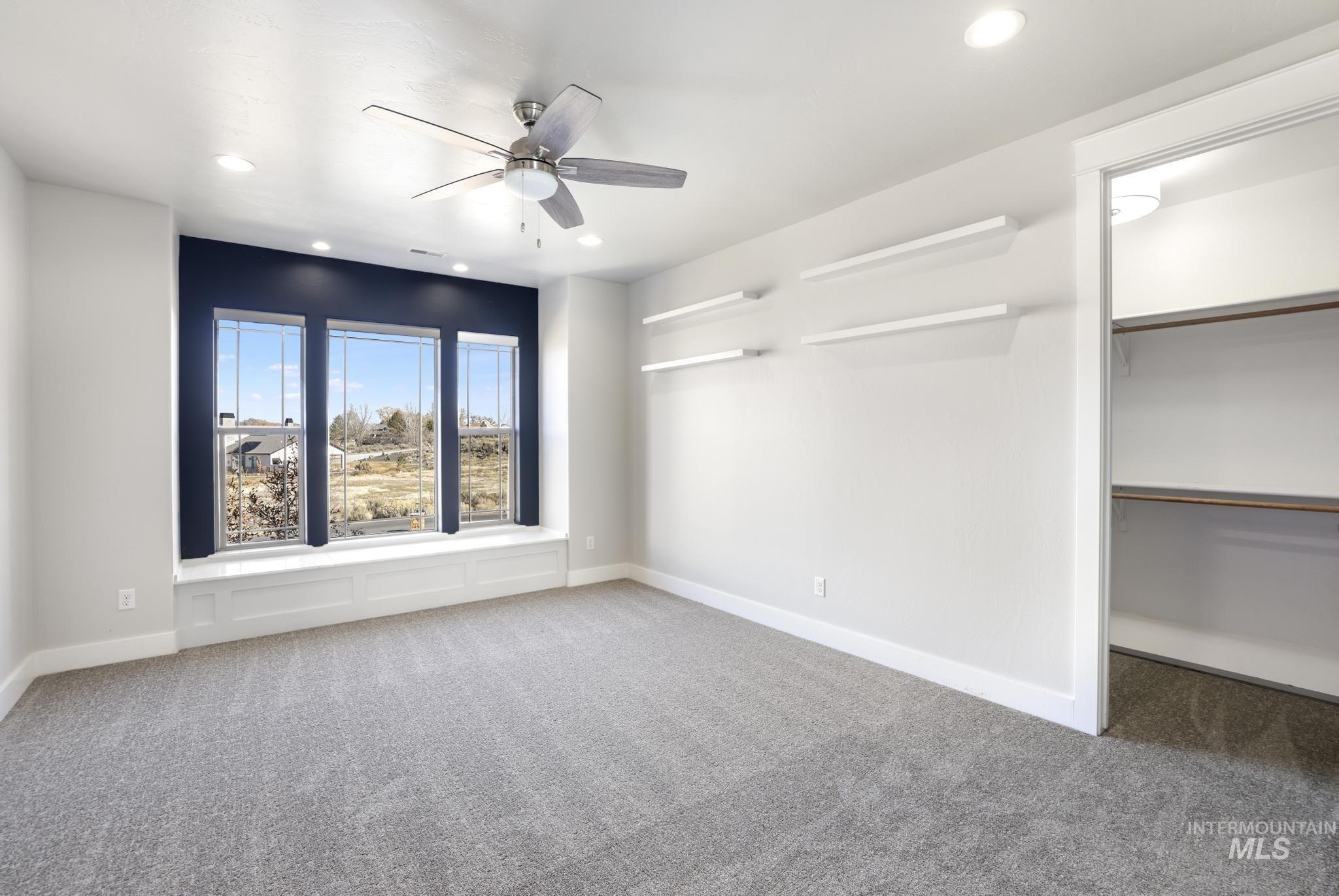 Empty room featuring recessed lighting, carpet flooring, and ceiling fan
