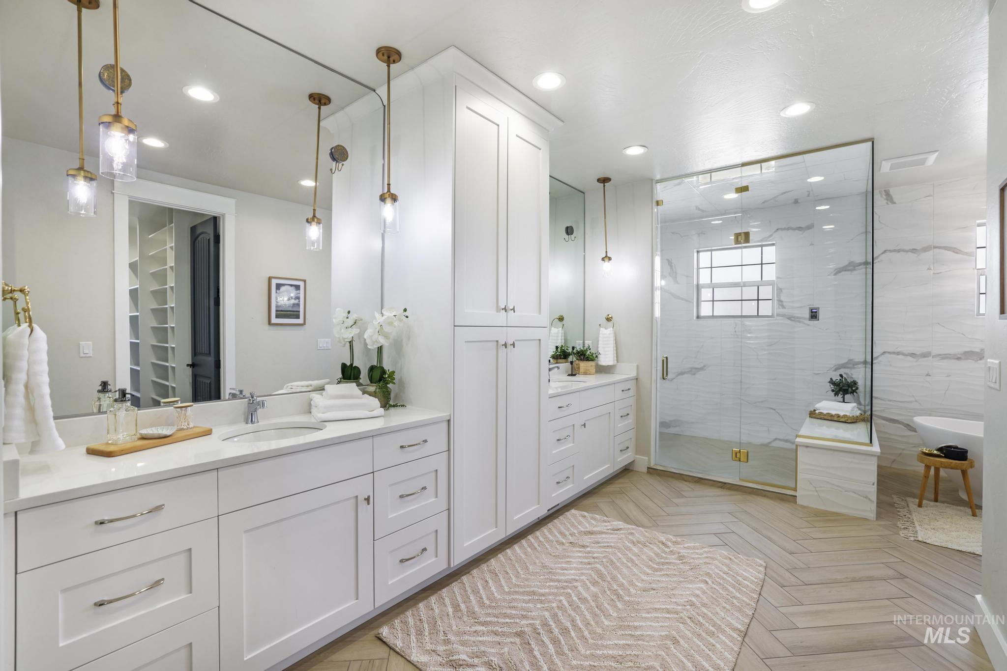 Bathroom with vanity, parquet floors, recessed lighting, a marble finish shower, and a freestanding bath
