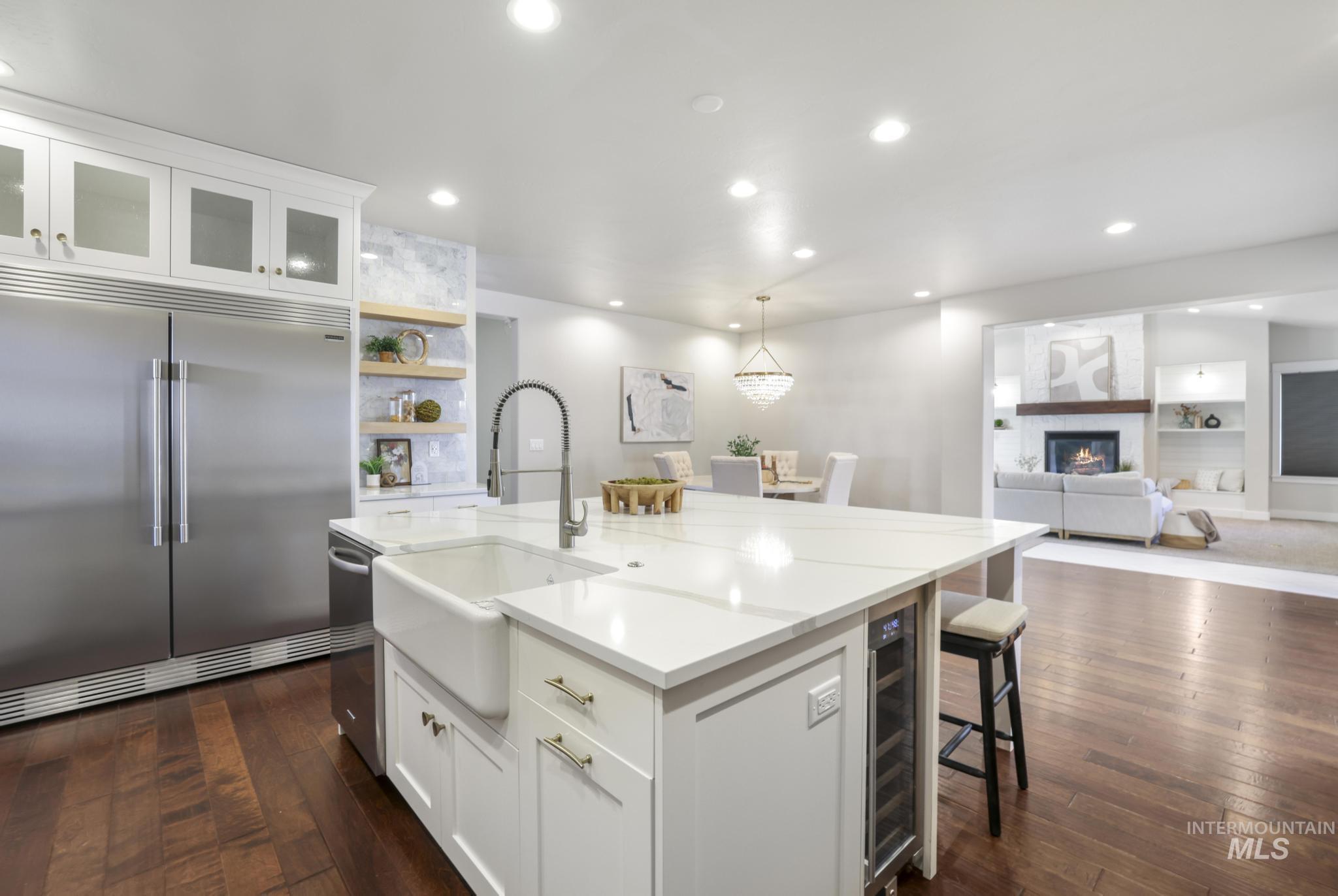 Kitchen featuring white cabinets, built in shelves, a breakfast bar, and open shelves