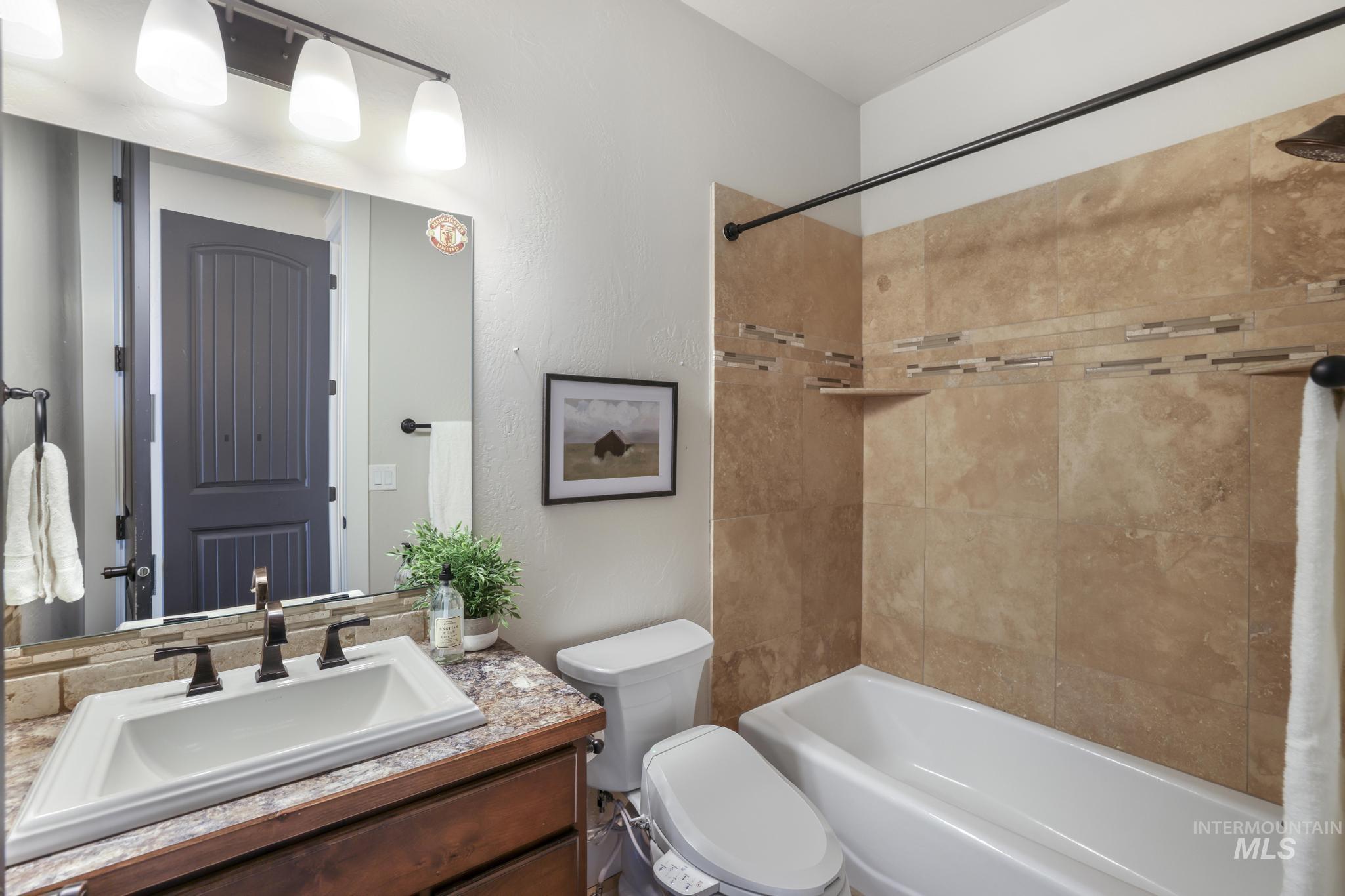 Bathroom with shower / bath combo and vanity