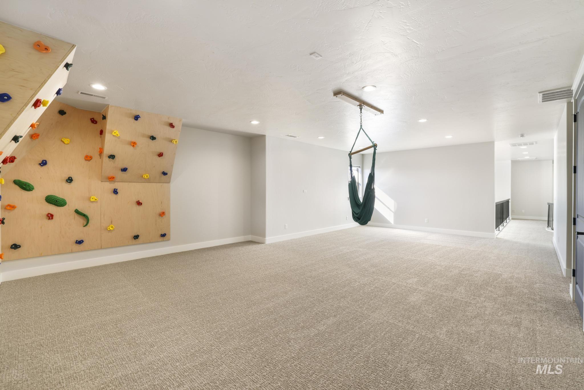 Empty room featuring light carpet and recessed lighting
