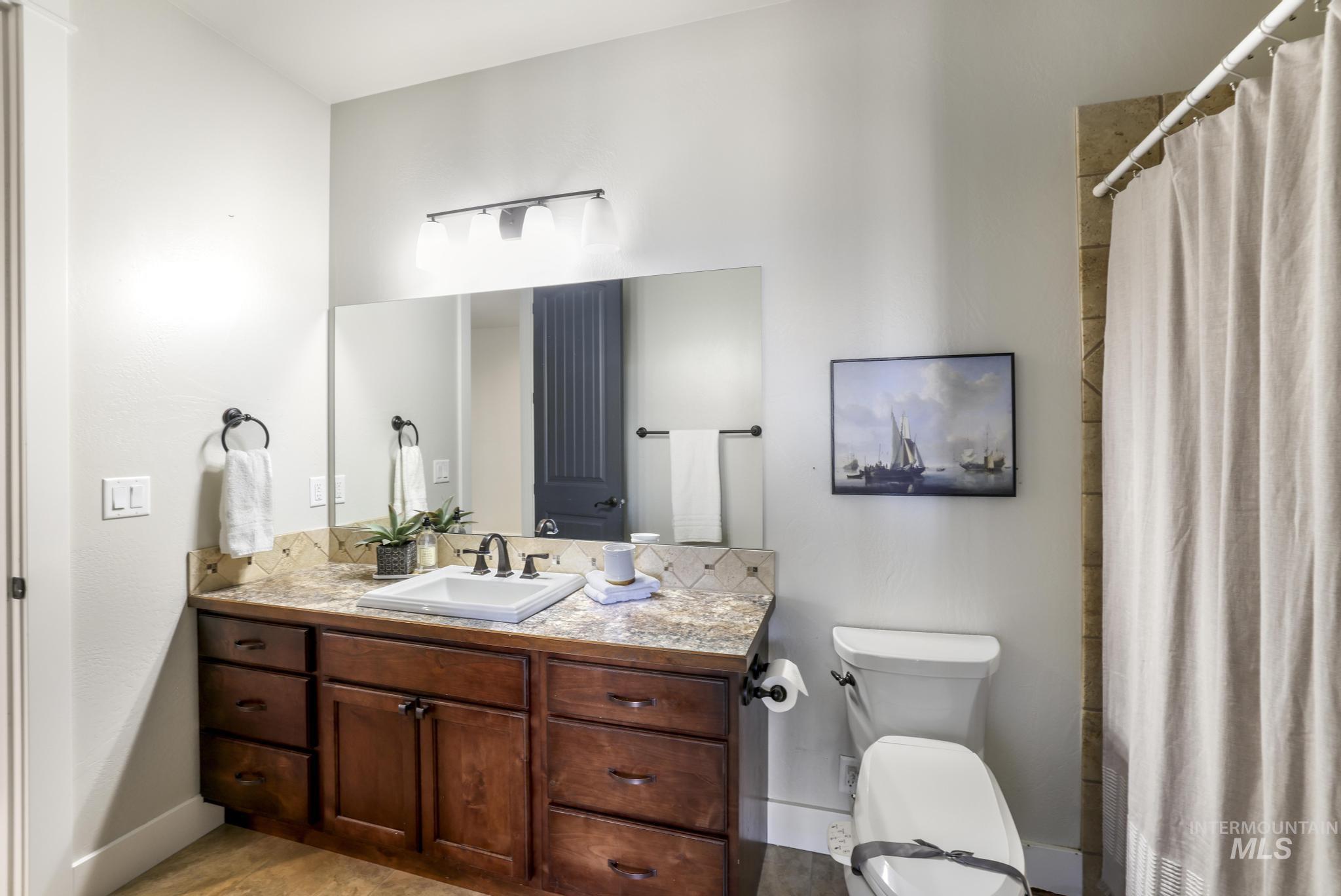 Bathroom featuring vanity and a shower with shower curtain