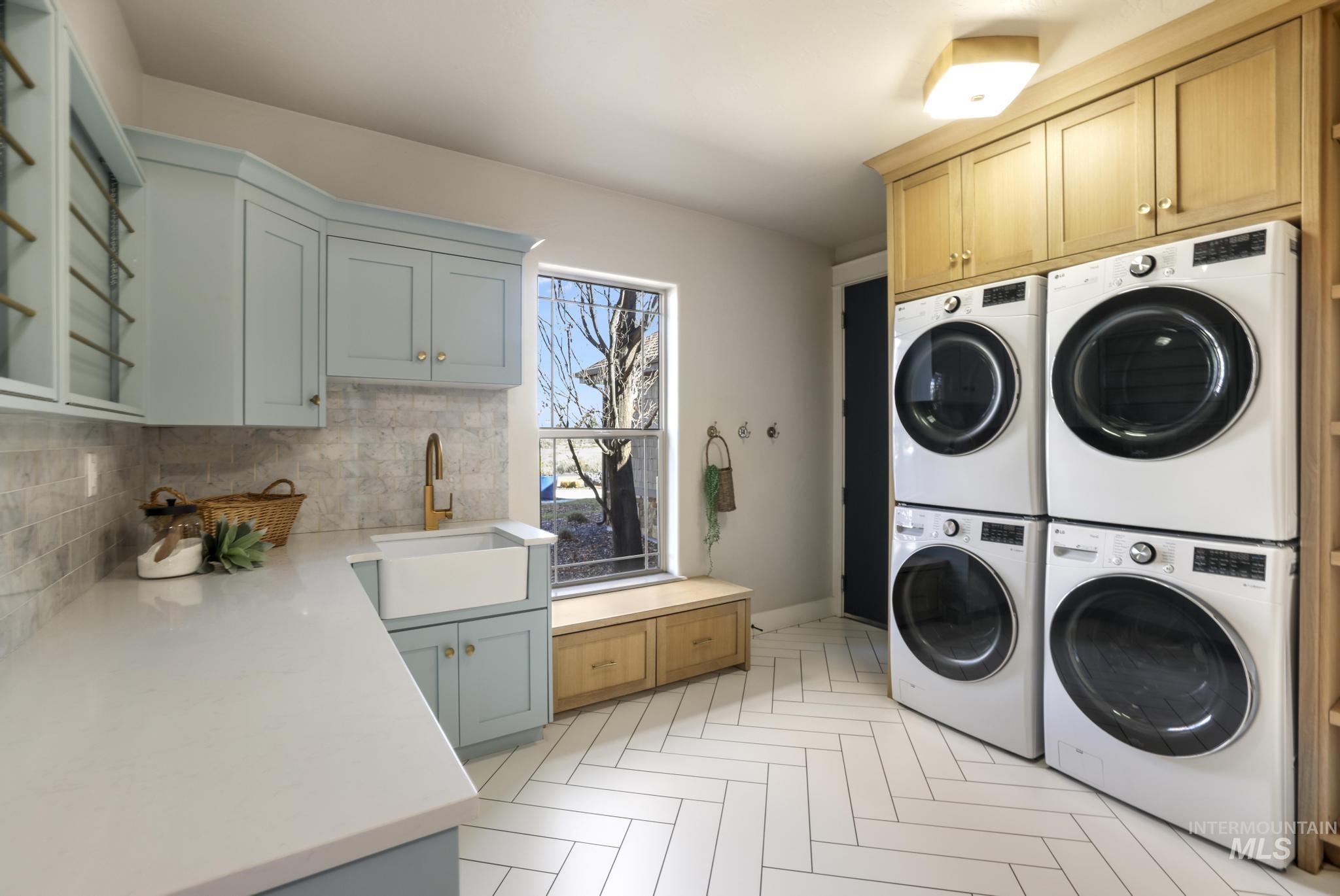 Laundry room with washing machine and clothes dryer and cabinet space