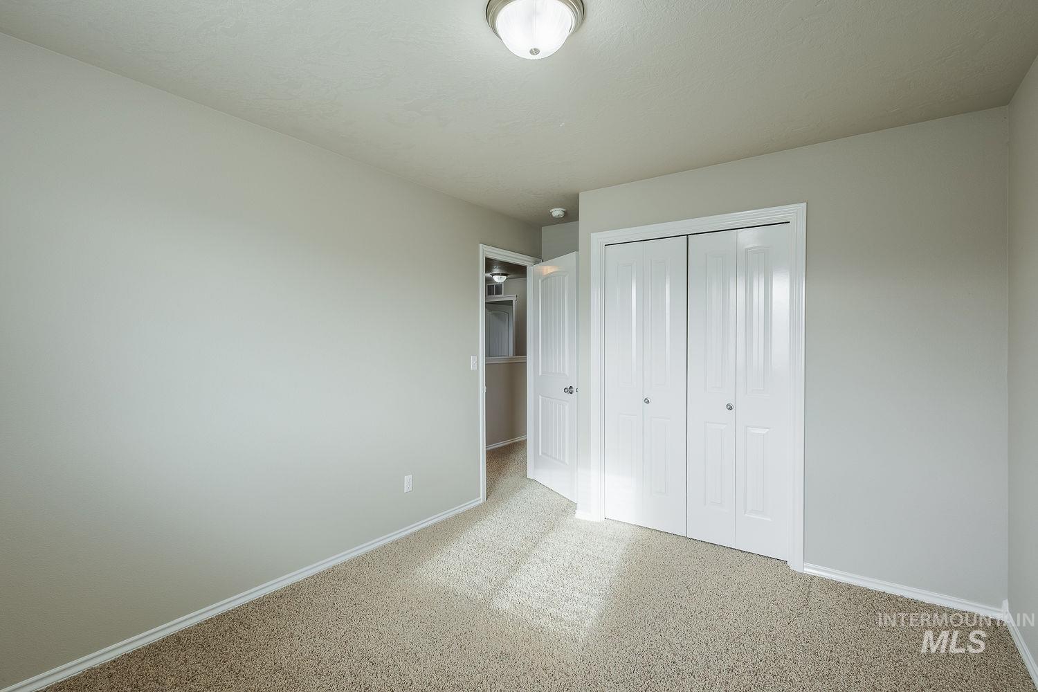 Unfurnished bedroom featuring a closet and baseboards
