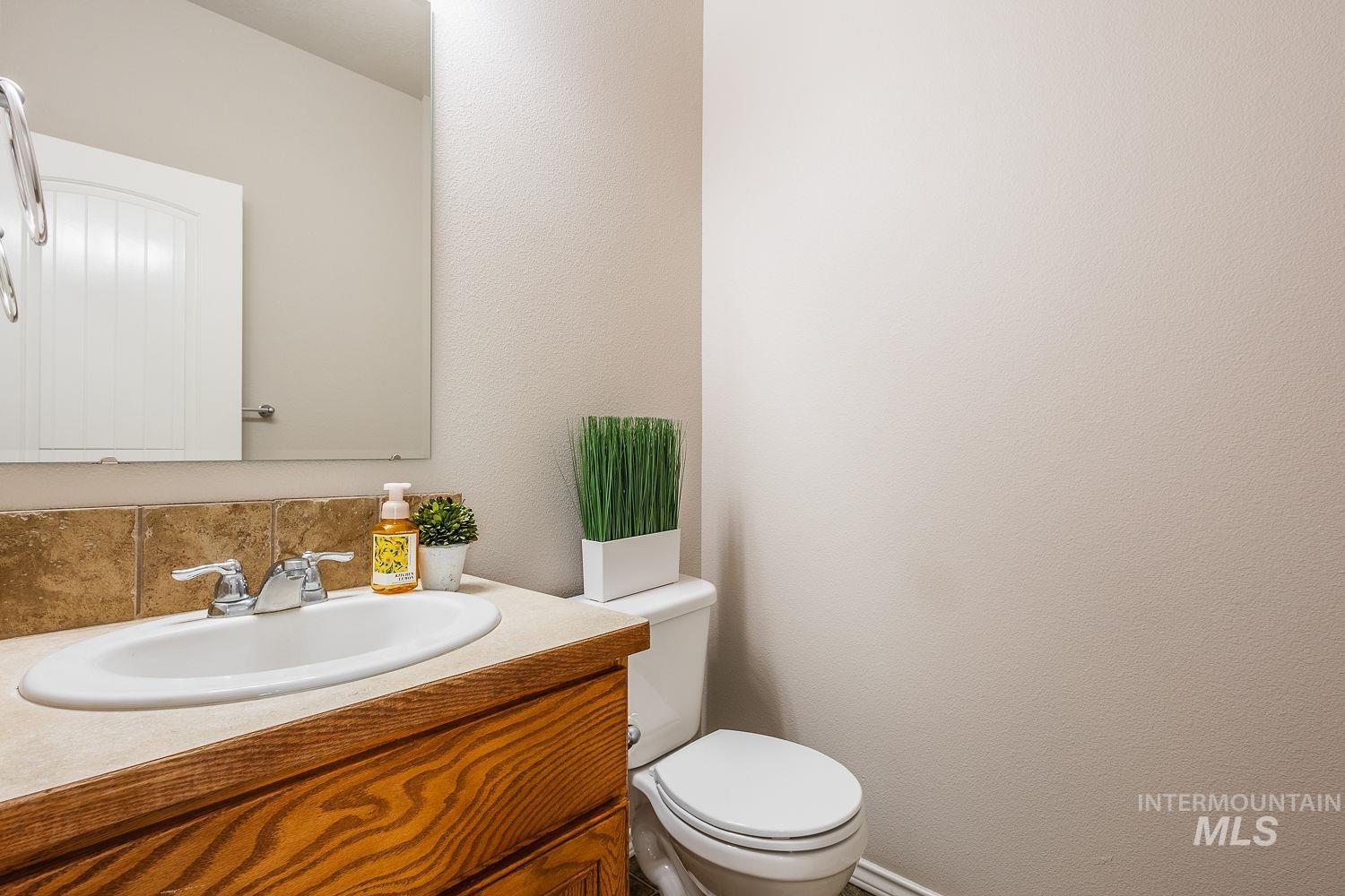 Bathroom featuring vanity and a textured wall