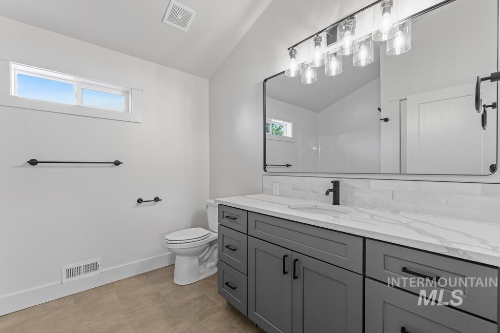 Bathroom with vaulted ceiling and vanity
