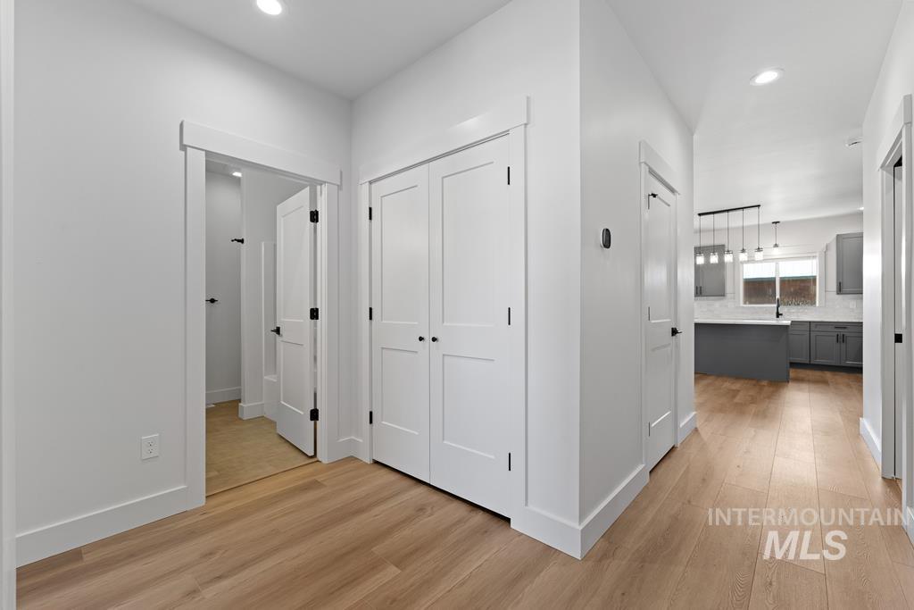 Hallway with recessed lighting and light wood finished floors