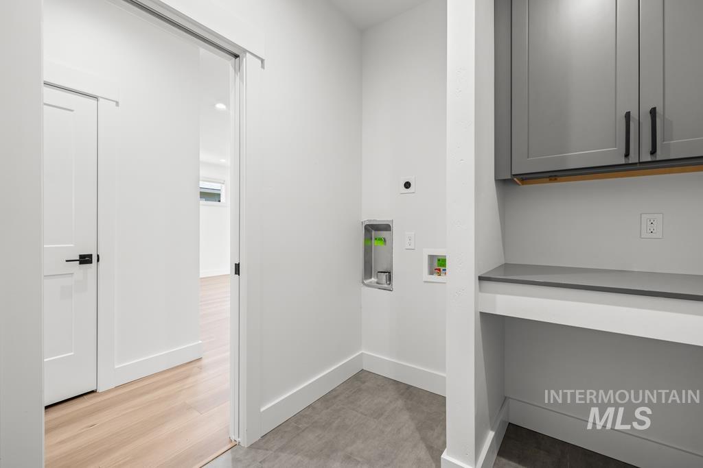 Laundry room with washer hookup, hookup for an electric dryer, and cabinet space