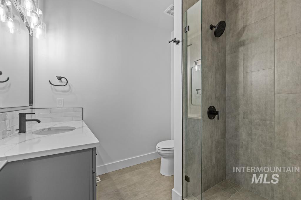 Full bath featuring vanity and a stall shower