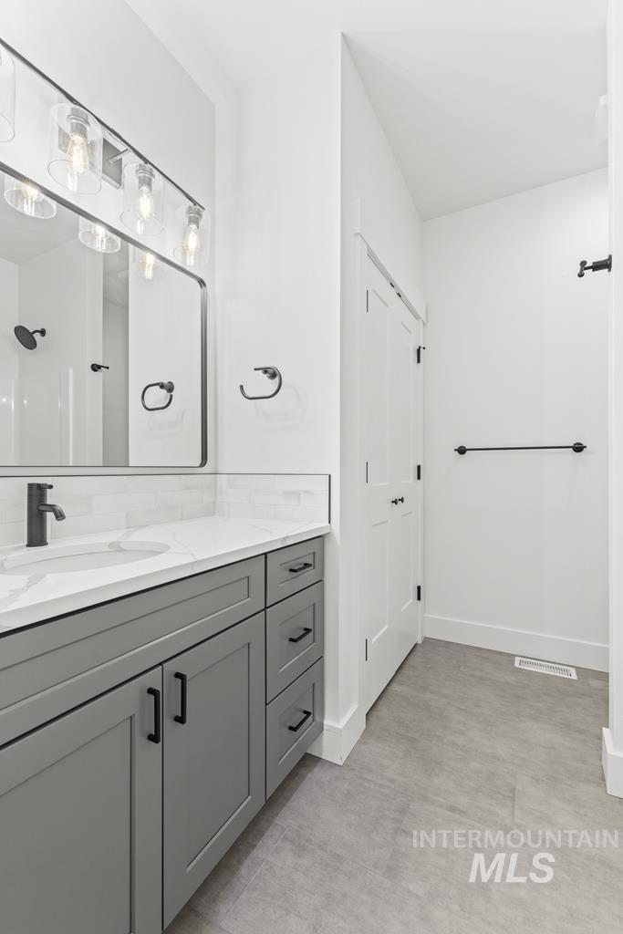 Bathroom featuring vanity and a shower