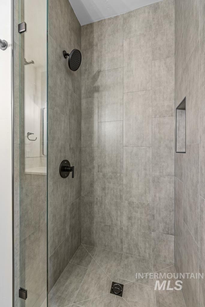 Full bathroom featuring a stall shower