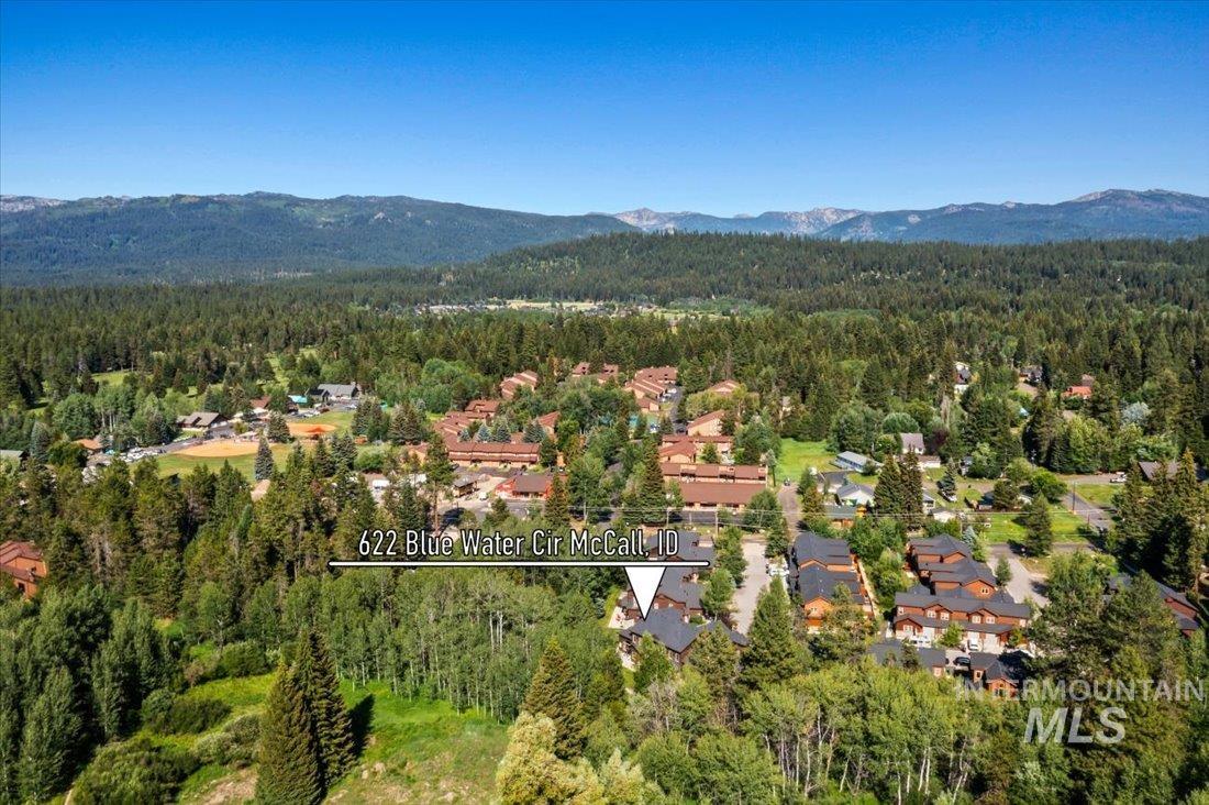 View of property location featuring a forest and mountains