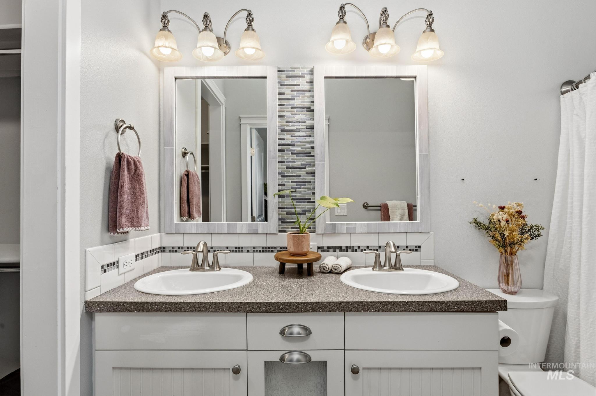 Full bathroom with tasteful backsplash and double vanity