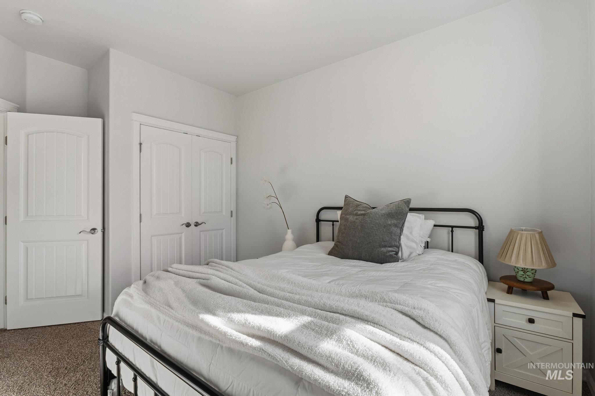 Bedroom featuring dark carpet and a closet