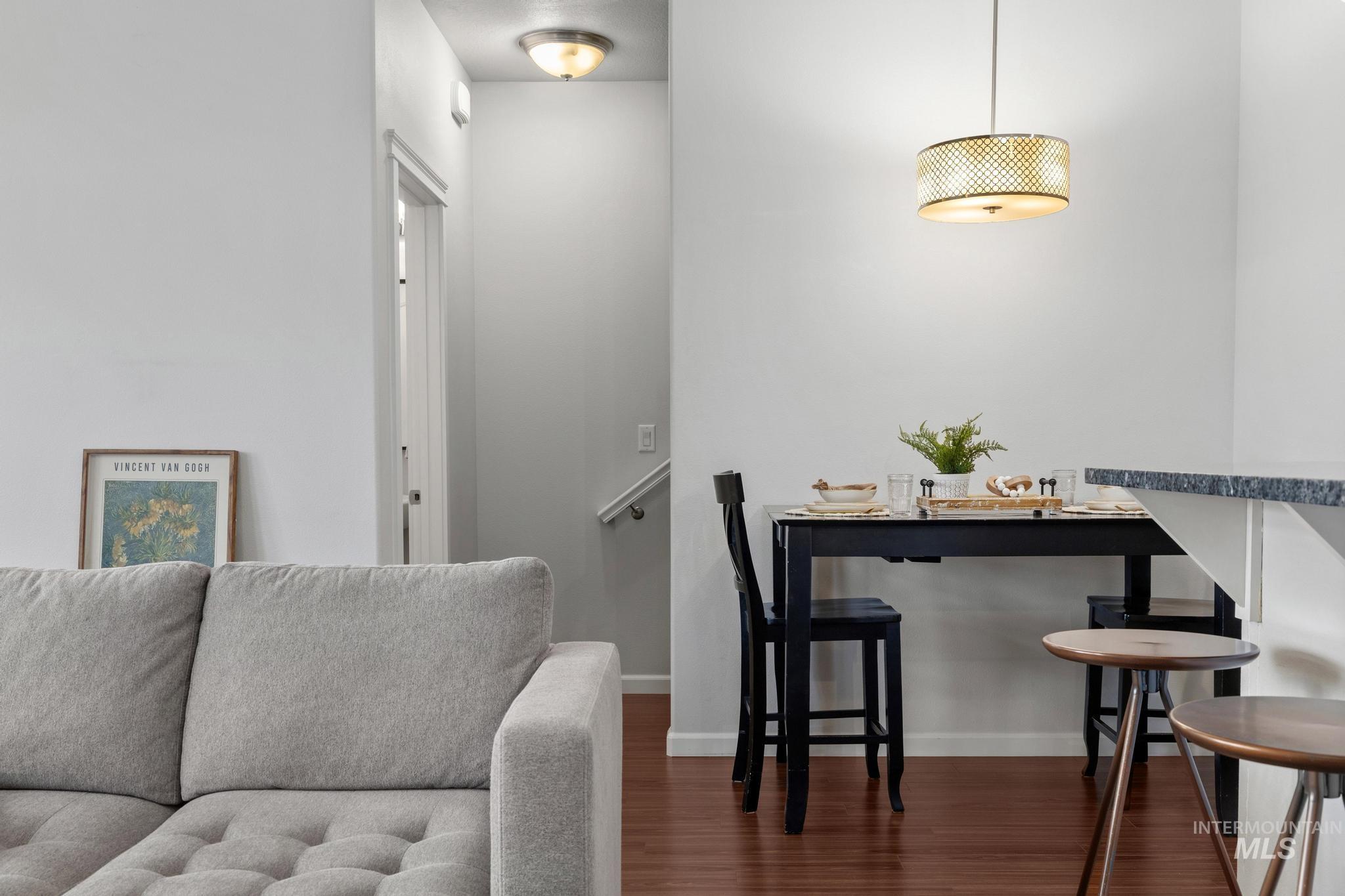 Dining room featuring dark wood-type flooring and baseboards