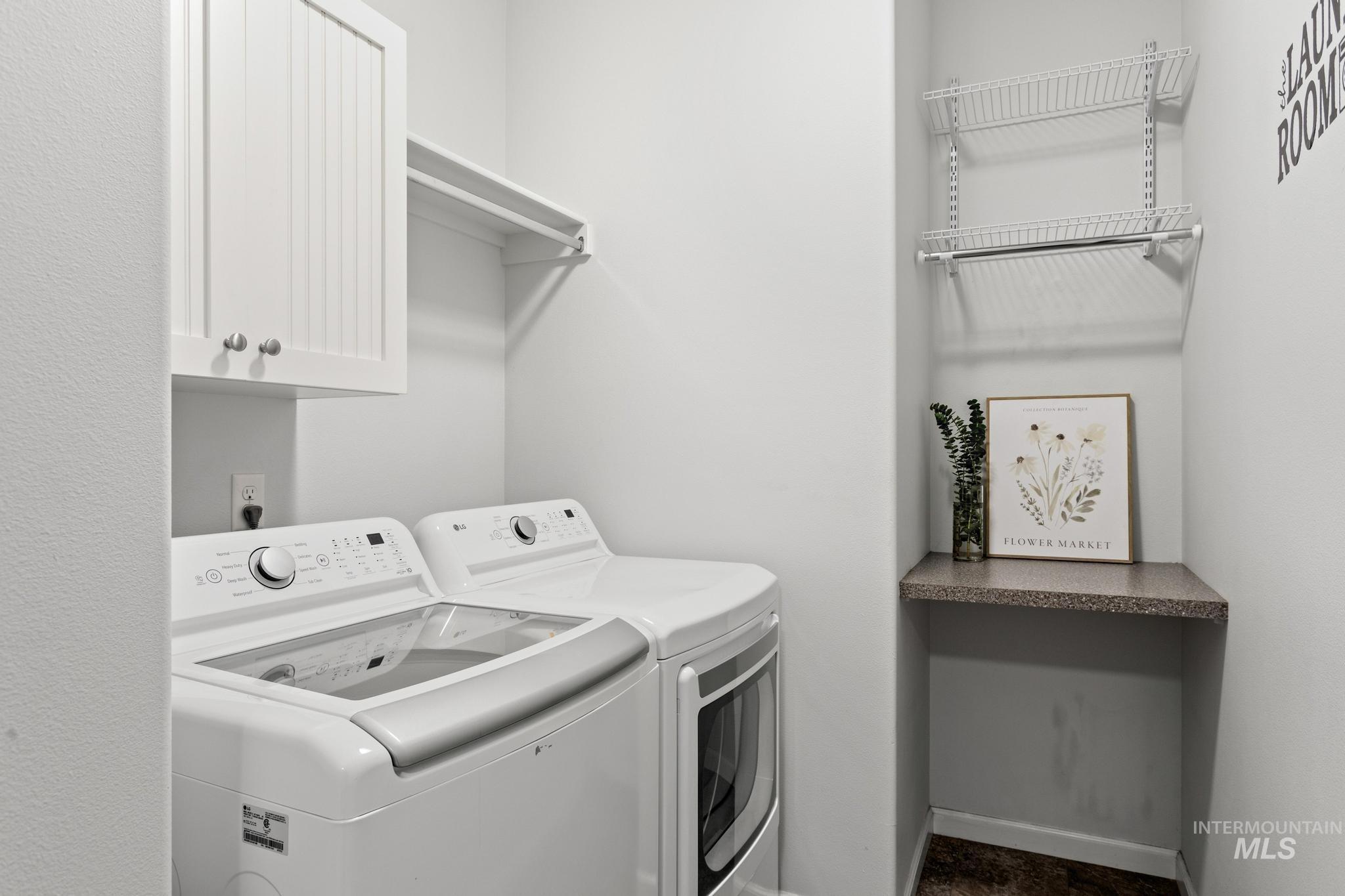 Laundry area with independent washer and dryer and cabinet space