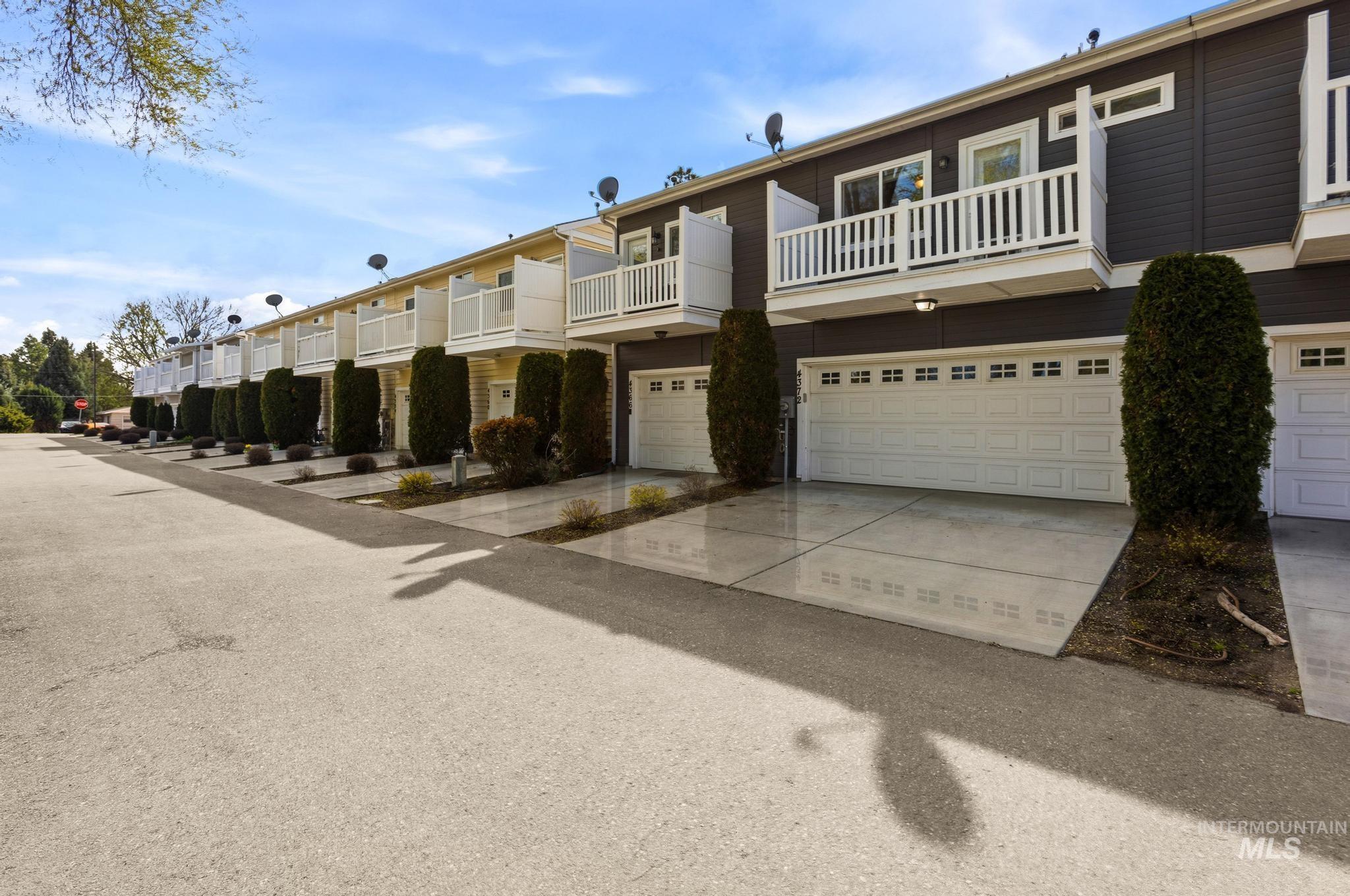 View of property featuring an attached garage and concrete driveway
